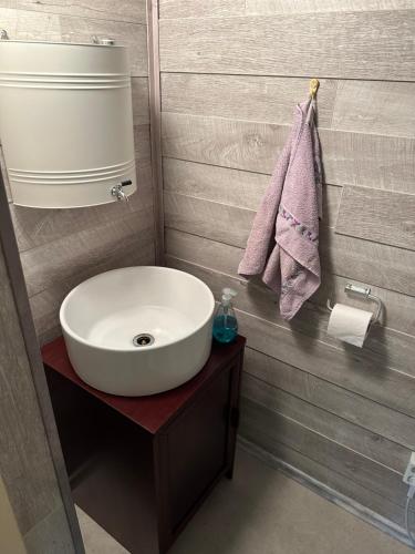 a bathroom with a white sink and a towel at Lillby Bed and breakfast2 in Lehtinen