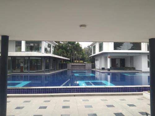 a large swimming pool in front of a building at PUSHPAM RANCHES and RESORT in Hosūr