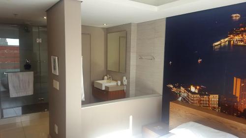a bathroom with a sink and a mirror at Apartment near V&A Waterfront & Convention Centre in Cape Town