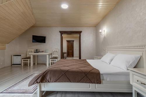 a bedroom with a bed and a table and chairs at Premium hotel & SPA in Bukovel