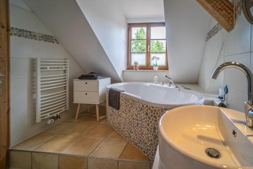 a bathroom with a large tub and a sink at Loft Ferienwohnung in Aschersleben