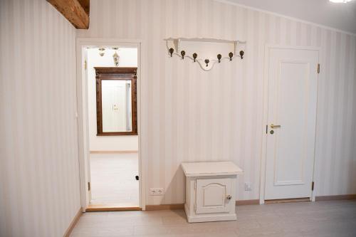 a room with a hallway with a door and a table at UKI Puhkeküla in Ranna