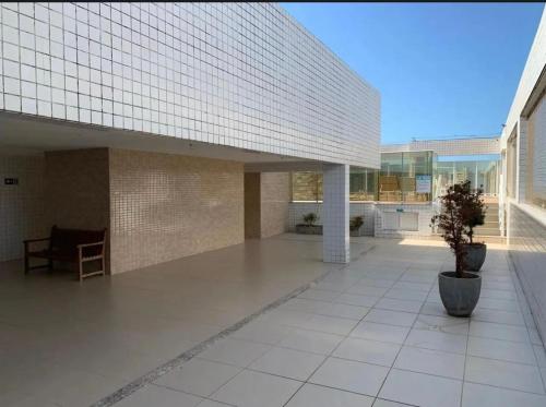 a large building with a white tiled floor at Quarto em Ap no Renascença in São Luís
