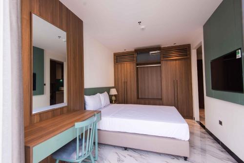 a hotel room with a bed and a television at Hoàng Cầu Paradise Hotel by Luxe Hospitaliy in Hanoi