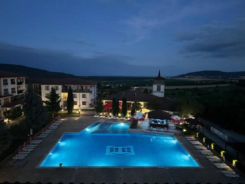 a view of a swimming pool at night at Harmony Hills Osteon Studio apartment in Rogachevo