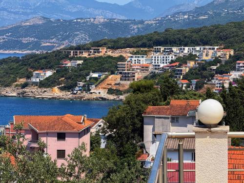 a group of buildings on a hill next to the water at Blue Seagull in Utjeha