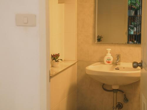 a bathroom with a sink and a mirror at Boxsoon Nimman 2 # 4beds 3baths in Chiang Mai