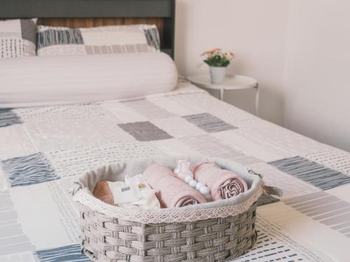 a basket of towels sitting on top of a bed at Boxsoon Nimman 2 # 4beds 3baths in Chiang Mai