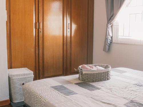 a bedroom with a crib and a basket on a bed at Boxsoon Nimman 2 # 4beds 3baths in Chiang Mai