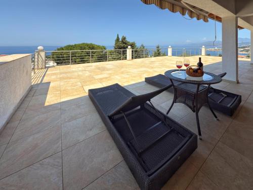 a patio with a table and a table and chairs at Blue Seagull in Utjeha