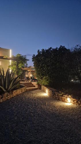 a pathway leading to a house at night with lights at Dome Bally Kampia in Kambiá