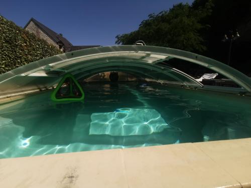 - une piscine avec un couvercle sur l'eau dans l'établissement Les trois Grottes, à Barbonval