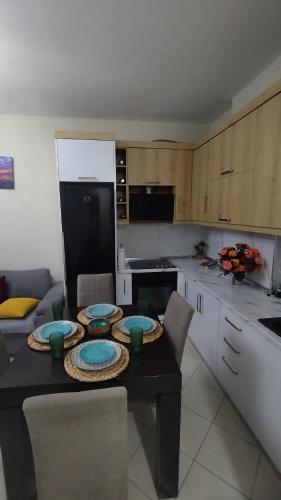 a kitchen with a table with plates on it at The Guest Apartment 2025 in Fier