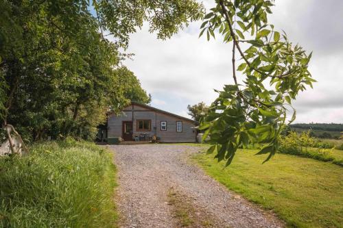 a house in the middle of a gravel road at Warriors View in Drumahayre
