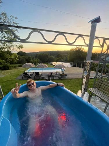 a man is in a swimming pool at Alba Góra Św Anny Restauracja i Pokoje in Góra Świętej Anny