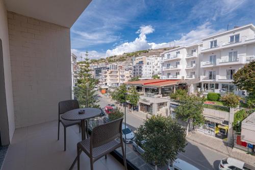 a balcony with chairs and a view of a city at Grand Hotel Saranda in Sarandë