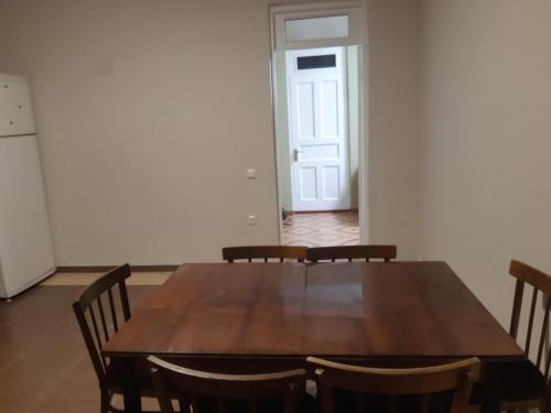 a dining room with a wooden table and chairs at Едик хаус in Chakvi