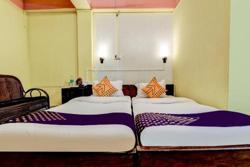 two twin beds in a room with at SPOT ON Durba 2 in Tezpur