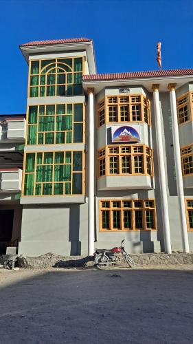 a building with a bike parked in front of it at Adventure Sarai Hotel Skardu in Skardu
