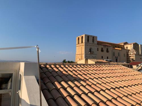 a view of a tile roof with a clock tower at Casa Cibella Authentic Charme Apartments in Agrigento