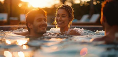 a man and a woman in a hot tub at Mercure Aix-les-Bains Domaine de Marlioz Hôtel & Spa in Aix-les-Bains