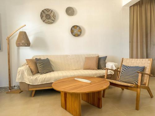 a living room with a couch and a table at Thalassea house2 Lipsi in Lipsoi