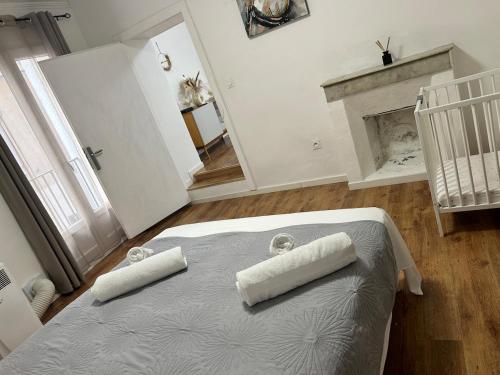 a bedroom with a bed with two pillows on it at Appartement Citadelle in Bonifacio