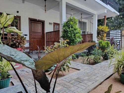 a house with a lot of plants in the yard at Elite Bay Arugambay in Arugam Bay