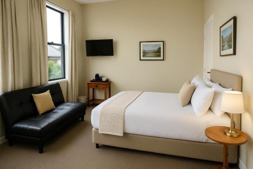 a hotel room with a bed and a chair at The Old Railway Hotel Lumsden in Lumsden