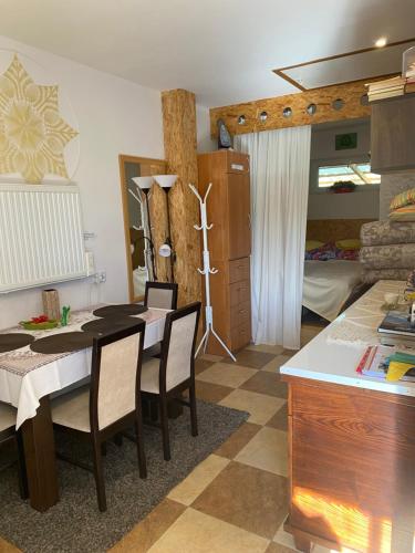 a dining room with a table and chairs and a bedroom at POKOJE GOŚCINNE RENATA KNITTER in Komnino