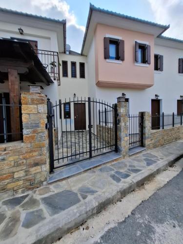 a gate in front of a white house at VillaMarialena #2, #4 in Kato Gatzea