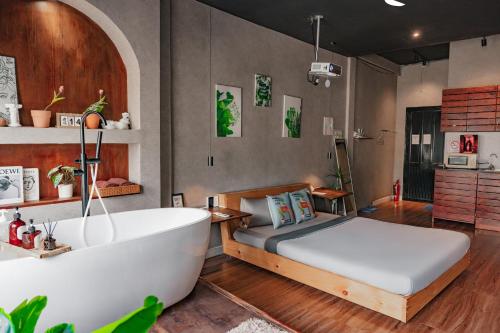 a bedroom with a tub and a bed and a bath tub at Saigon Hideout New World View in Ho Chi Minh City