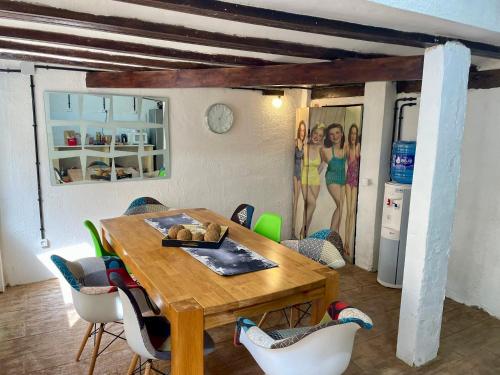 a dining room with a wooden table and chairs at La Terreta hotel casa rural in El Brosquil