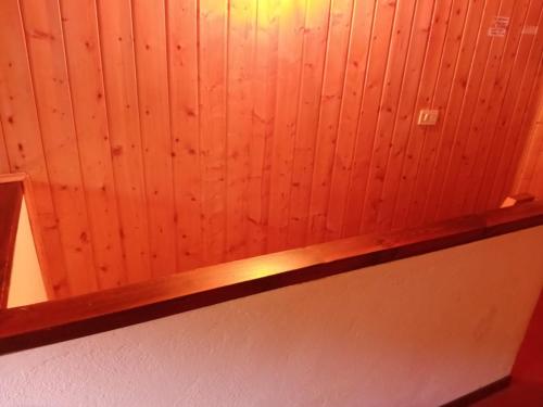 a wooden wall with a wooden shelf in a room at Sleep in peace, "read all" dormire in pace in Albosaggia
