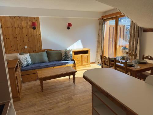 un salon avec un canapé et une table dans l'établissement Les Orres 1800 - 6 pers - Piscine, aux Orres