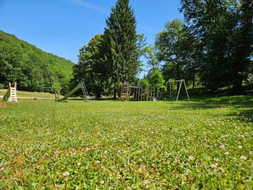 a park with a playground and a swing set at Font Neuve in Souillac