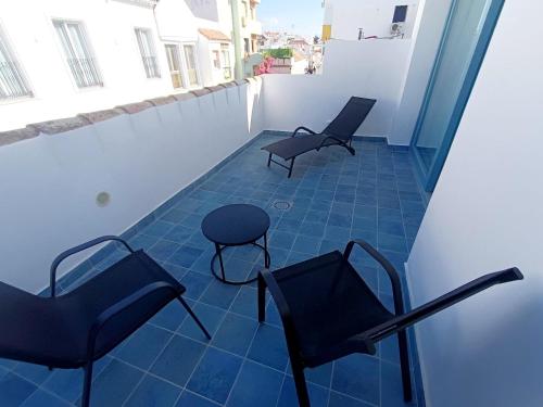two chairs and a stool sitting on a balcony at Hotel Boutique La Brisa del Mar in Estepona