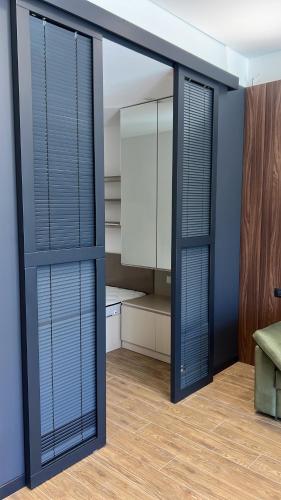 a room with blue walls and sliding glass doors at RM Apartment Sea Breeze in Baku