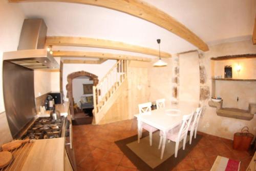 - une cuisine et une salle à manger avec une table et une cuisinière dans l'établissement The Little Pink House Eau De Thermale Avène, à Le Bousquet-dʼOrb