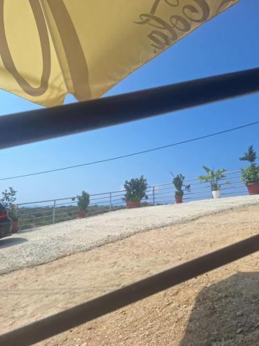 a view of the ocean from under a tent at KAFUL APARTMENTS in Qeparo
