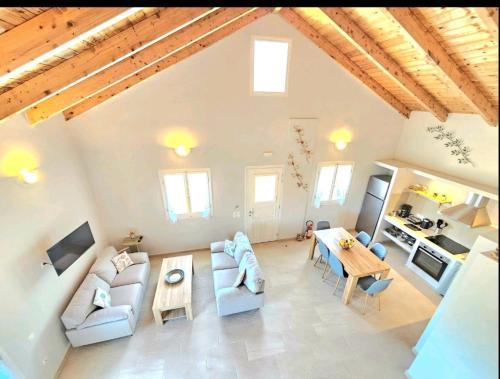a living room with two couches and a table at OLiVE HOUSE in Vathi, Ithaka