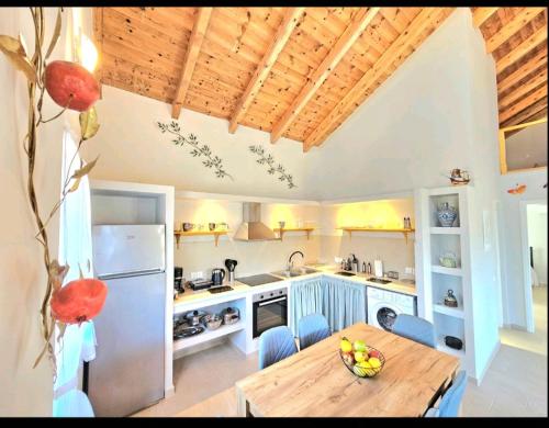 a kitchen with a wooden table and a refrigerator at OLiVE HOUSE in Vathi, Ithaka