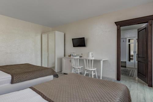 a hotel room with two beds and a table at Premium hotel & SPA in Bukovel