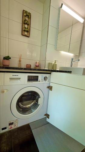 a kitchen with a washing machine in a kitchen at Oldtown central - amazing views in Unterseen
