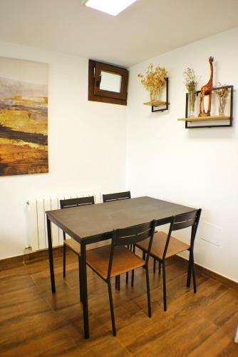a black dining room table with chairs in a room at El Tujo in Obregon