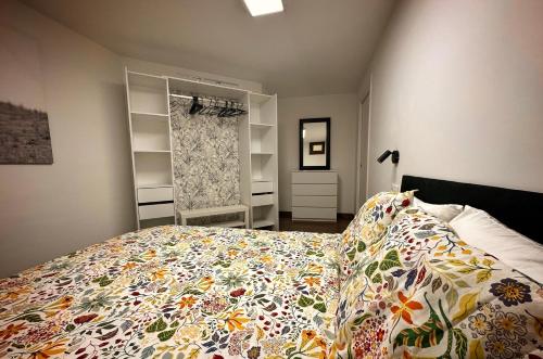 a bedroom with a bed with a flowered blanket on it at El Tujo in Obregon