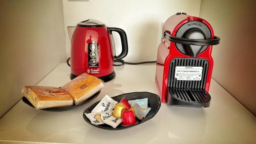 a counter top with a red blender and some food at El Tujo in Obregon
