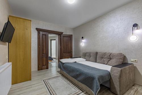 a bedroom with a bed and a tv in it at Premium hotel & SPA in Bukovel