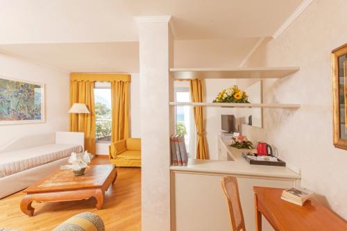 a living room with a couch and a table at Baia D'Argento in Porto Santo Stefano