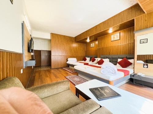 a living room with two beds and a couch at Near Chauk Bazaar Marvel International & Restaurant HD Lama Rd in Darjeeling